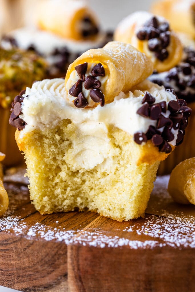 cupcakes with cannoli filling, cut in half, topped with a mini cannoli.