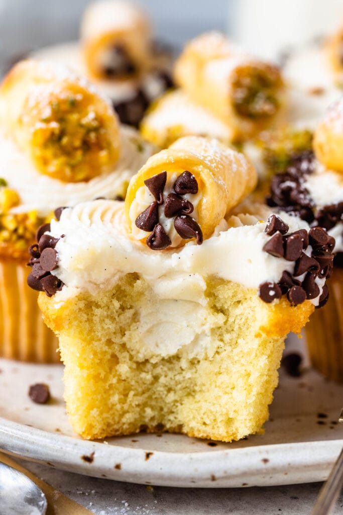 cupcakes with cannoli filling, cut in half, topped with a mini cannoli.