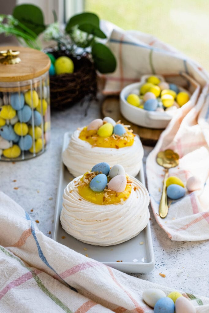 easter pavlovas topped with lemon curd and mini cadbury eggs.