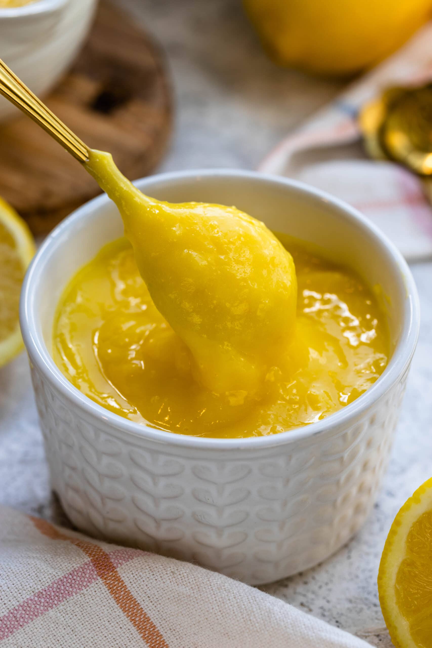 Lemon Curd in a bowl with a spoon.