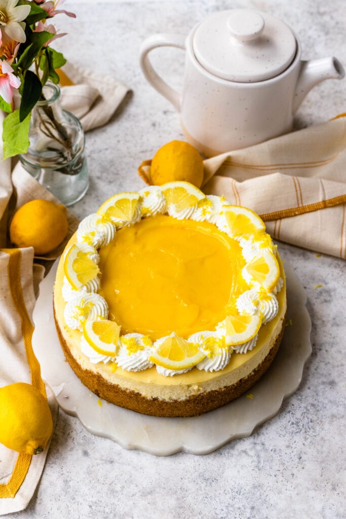Lemon Cheesecake topped with lemon curd and whipped cream.