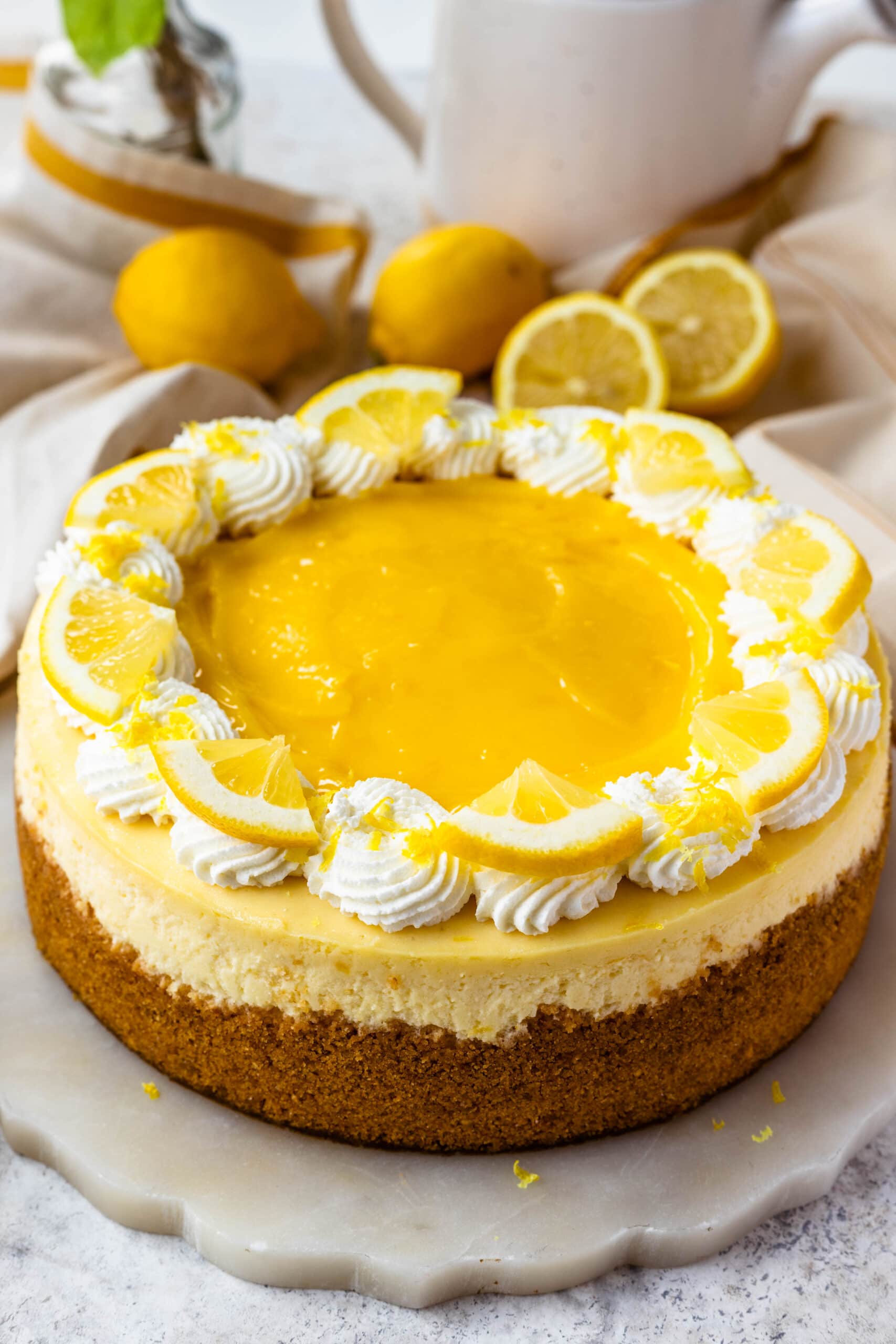 Lemon Cheesecake topped with lemon curd and whipped cream.