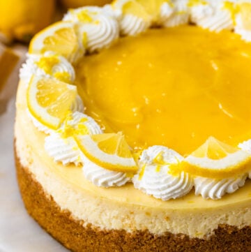 Lemon Cheesecake topped with lemon curd and whipped cream.