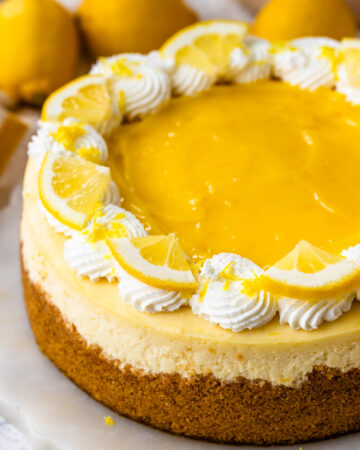 Lemon Cheesecake topped with lemon curd and whipped cream.