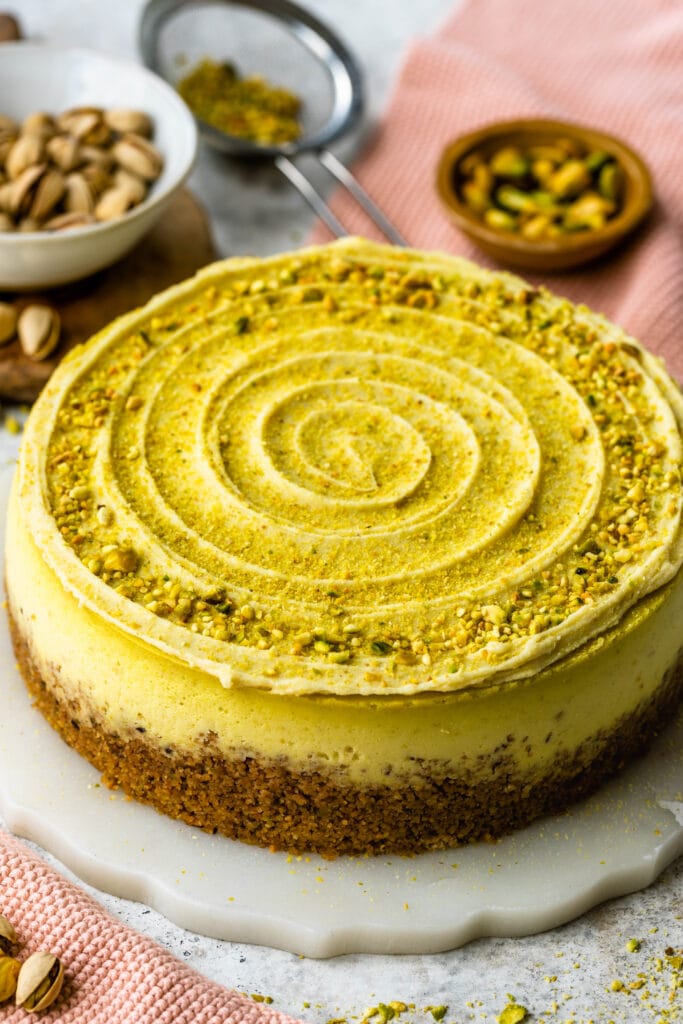 pistachio cheesecake with chopped pistachios on top.