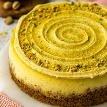 pistachio cheesecake with chopped pistachios on top.