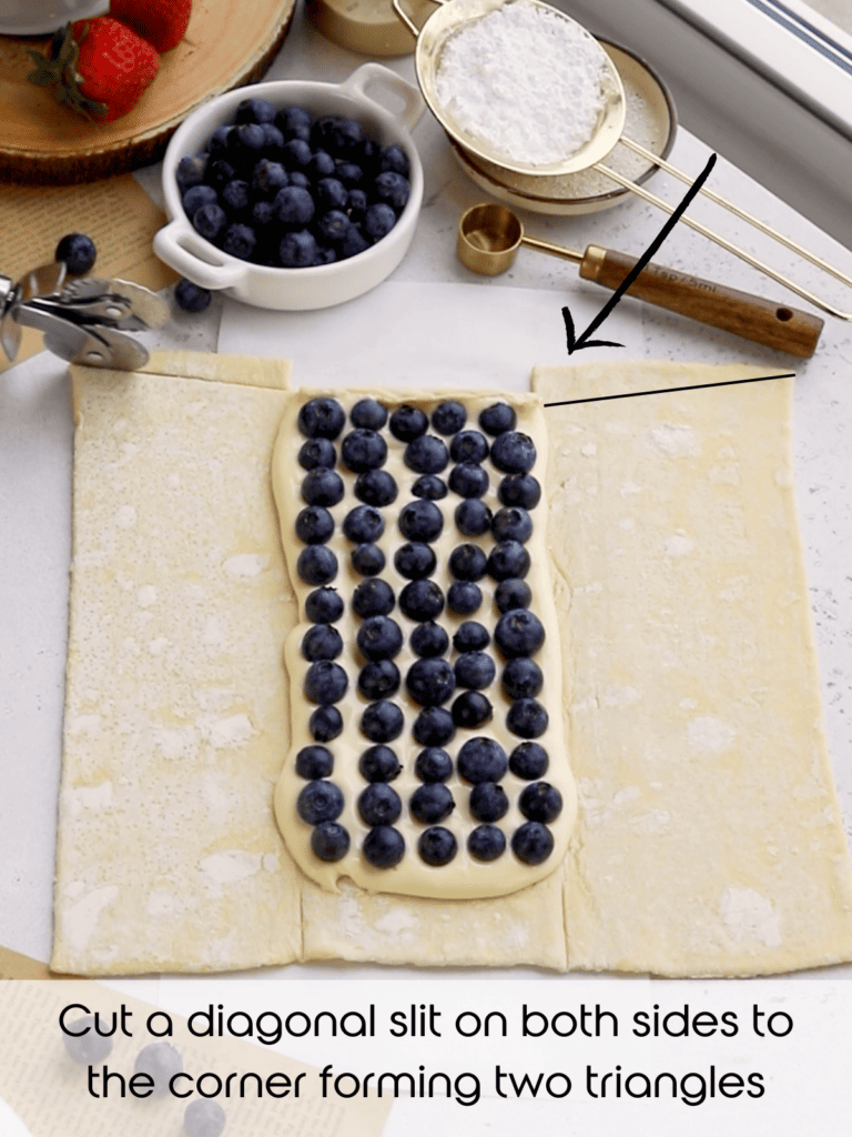 cutting a diagonal slit on both sides of the corner to form two triangles on the top of the pastry.