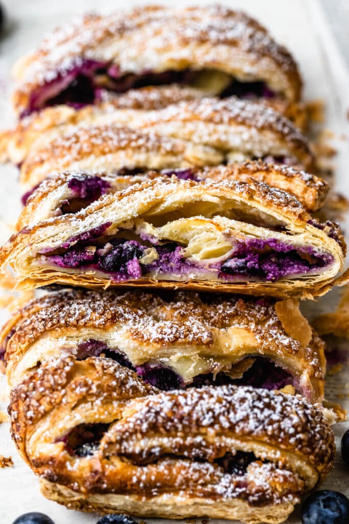 blueberry puff pastry sliced showing a delicious blueberry and cream cheese filling.