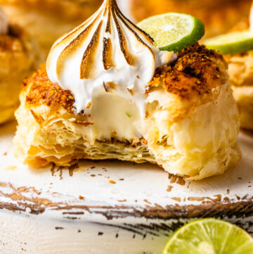 Key lime pastry cut in half with marshmallow frosting on top.