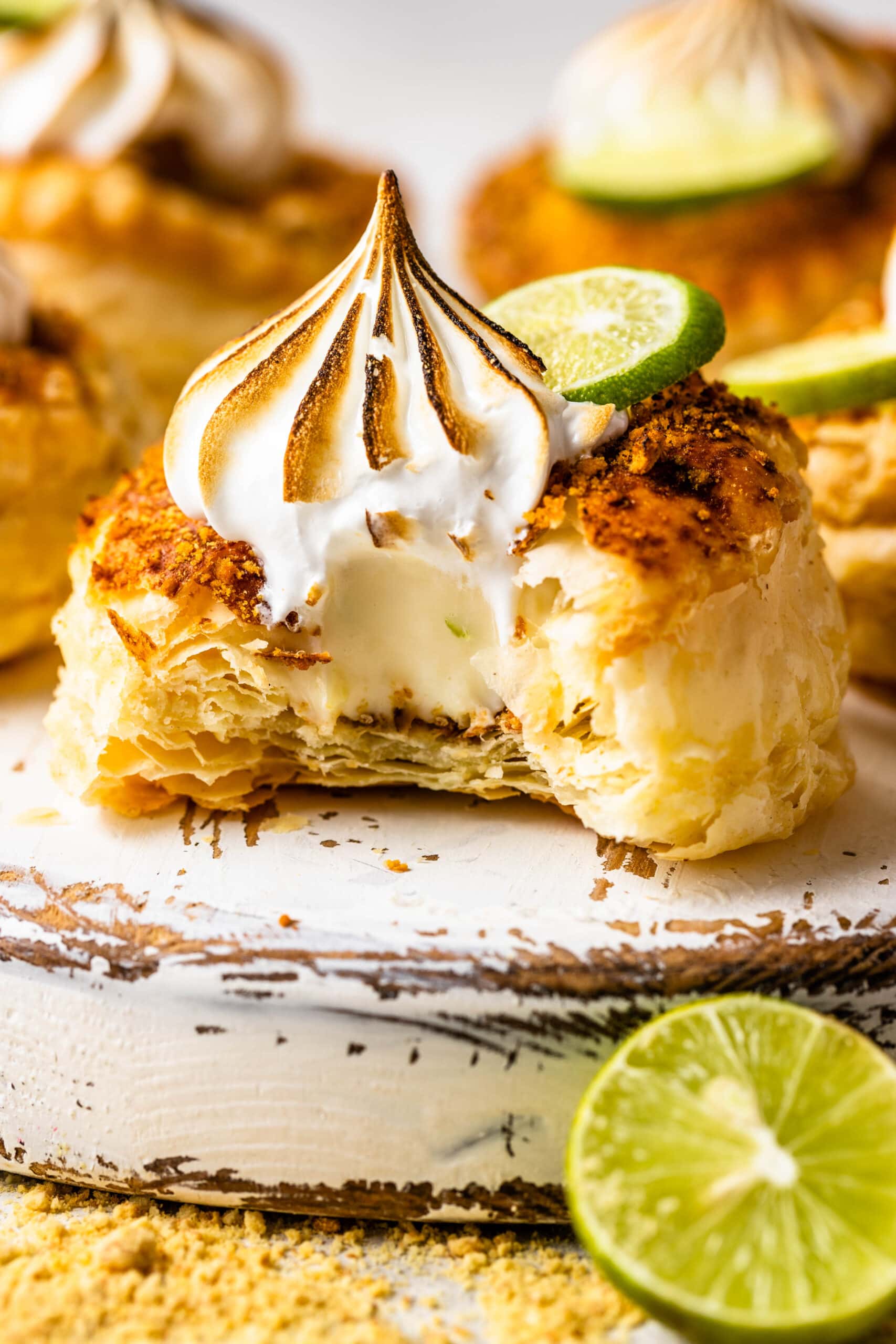 Key lime pastry cut in half with marshmallow frosting on top.