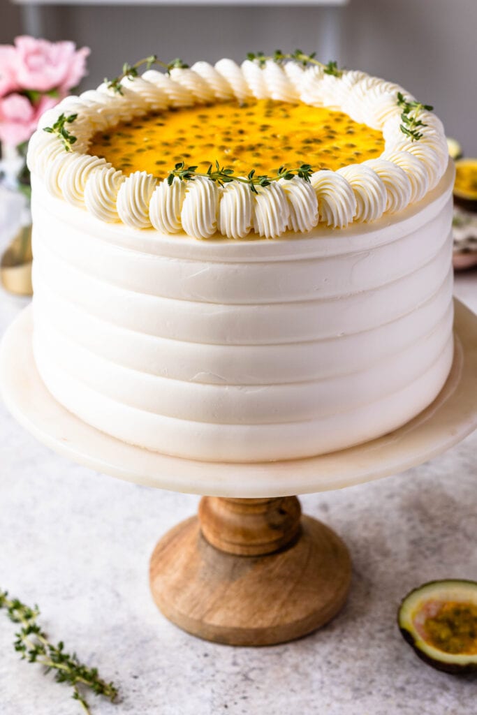 Passionfruit Cake frosted with Swiss meringue buttercream, topped with passionfruit seeds.