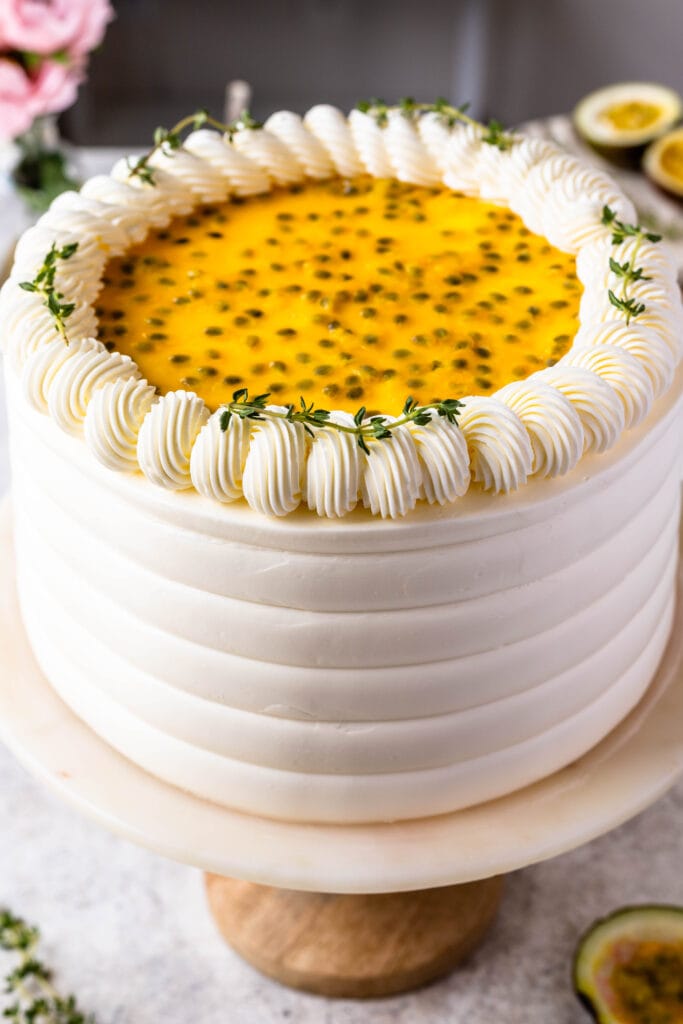 Passionfruit Cake frosted with Swiss meringue buttercream, topped with passionfruit seeds.