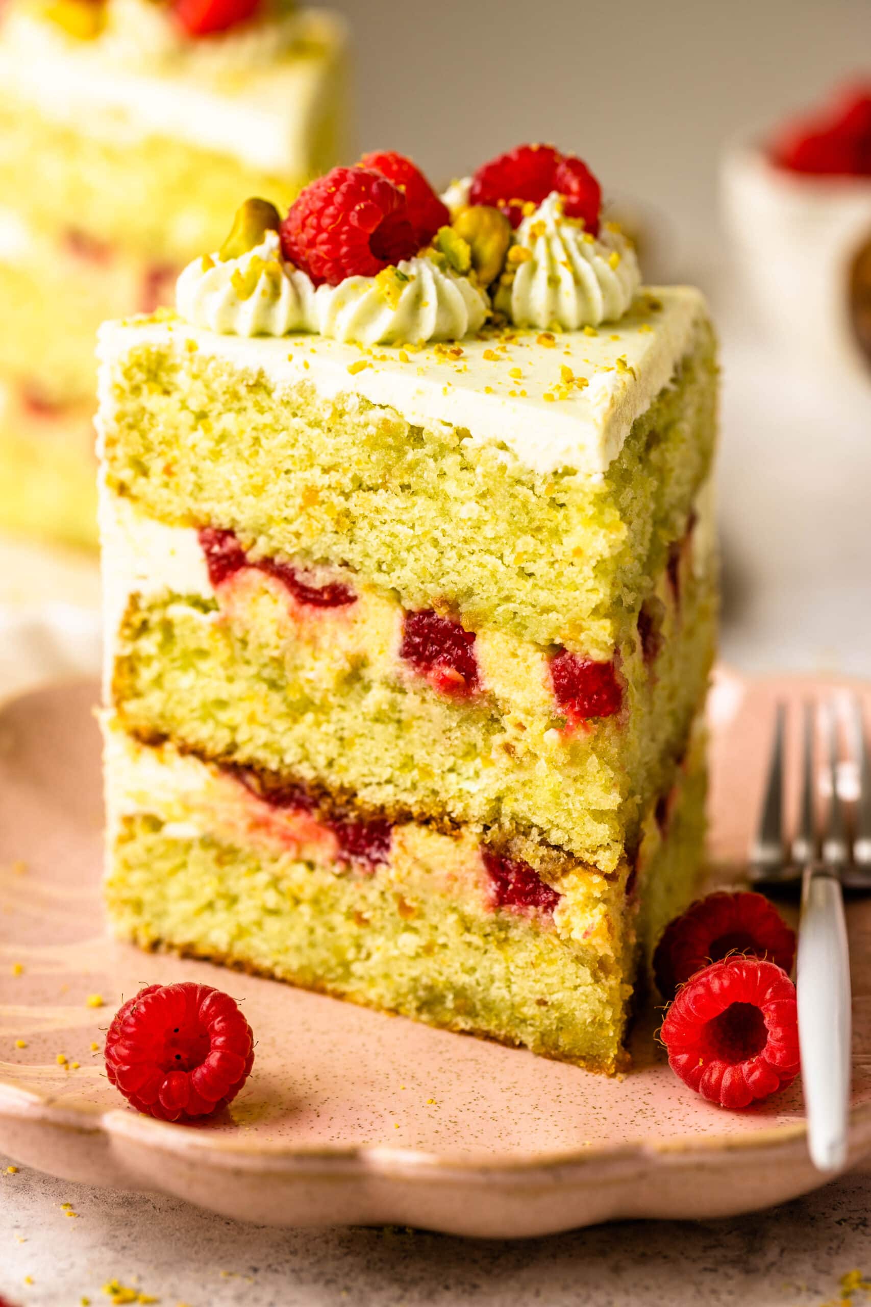 slice of pistachio raspberry cake.