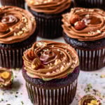 Nutella cupcakes with hazelnuts on top.