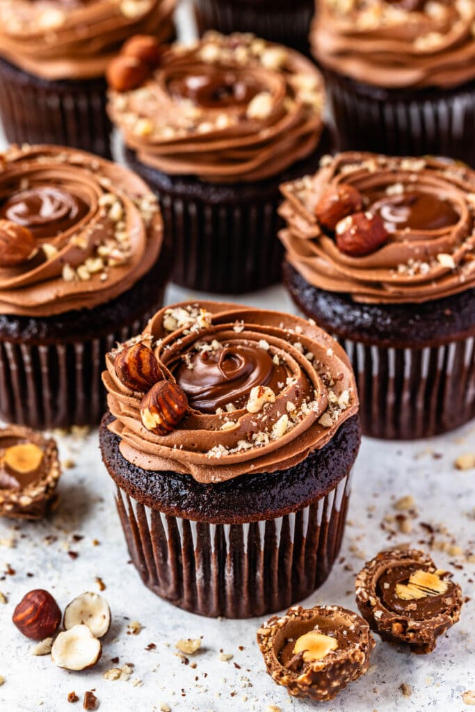 Nutella cupcakes with hazelnuts on top.