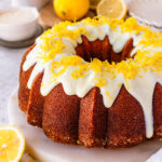lemon bundt cake with glaze on top, and lemon zest.