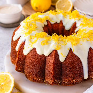 lemon bundt cake with glaze on top, and lemon zest.