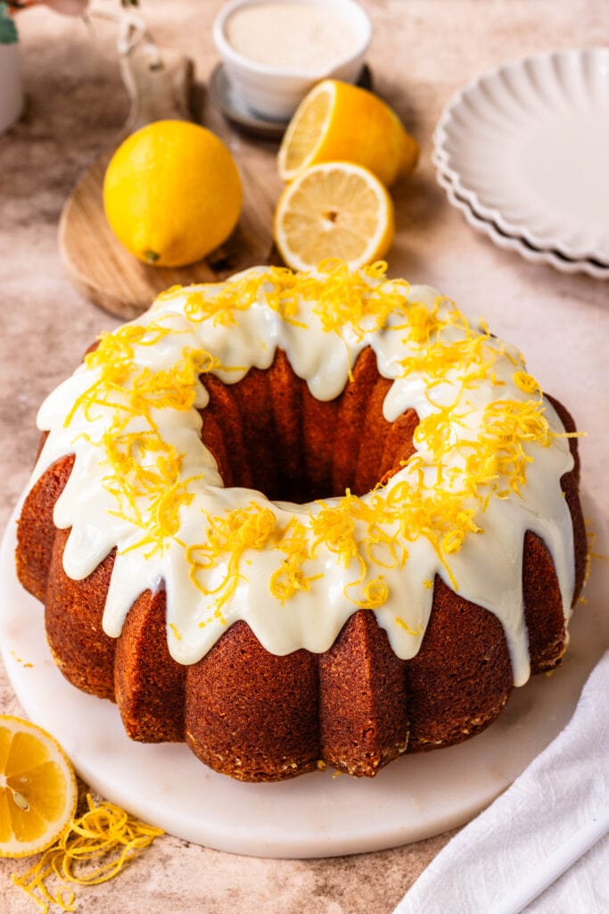 lemon pound cake with glaze on top and lemon zest.