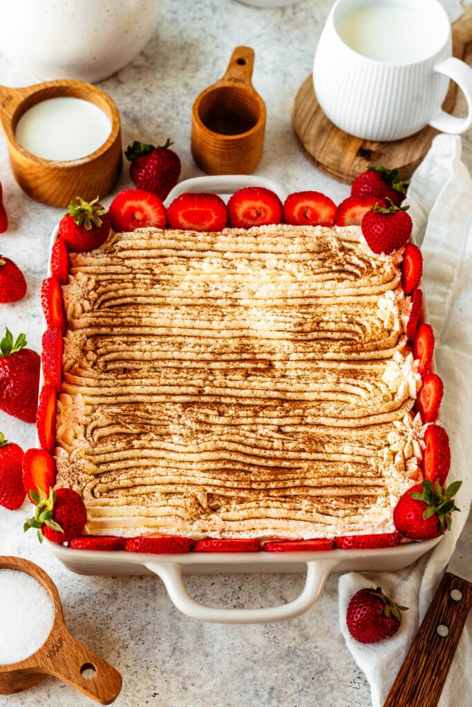 tres leches cake decorated with strawberries on top.
