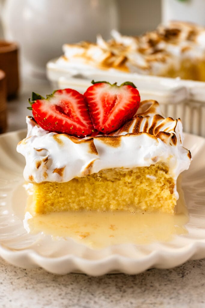 slice of tres leches cake with strawberries on top.