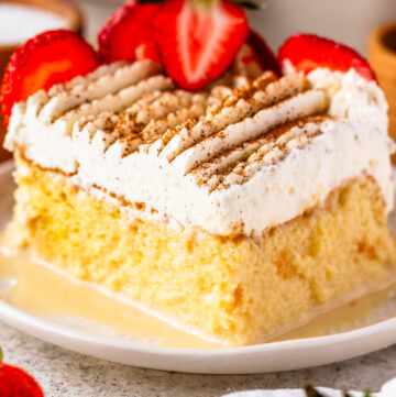 Tres leches cake slice on top of a plate.