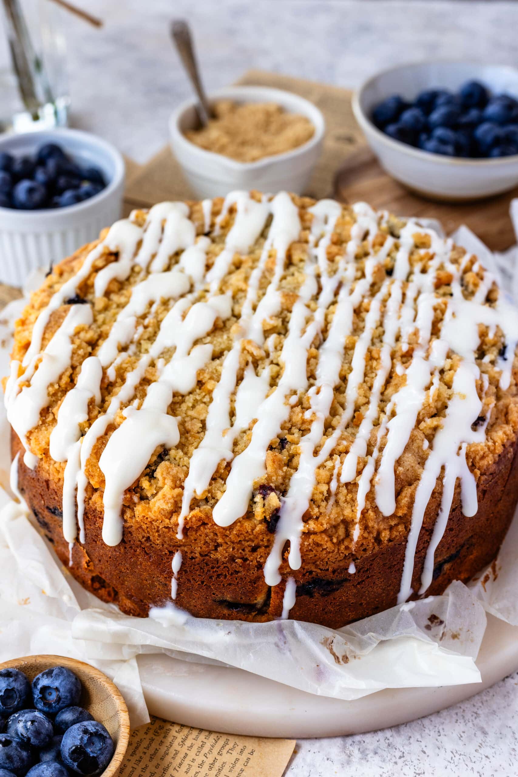 blueberry coffee cake with glaze on top.