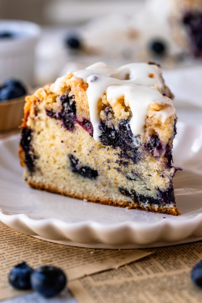 slice of blueberry coffee cake with drizzle on top.