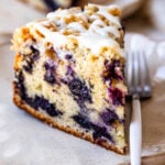 slice of blueberry coffee cake with drizzle on top.
