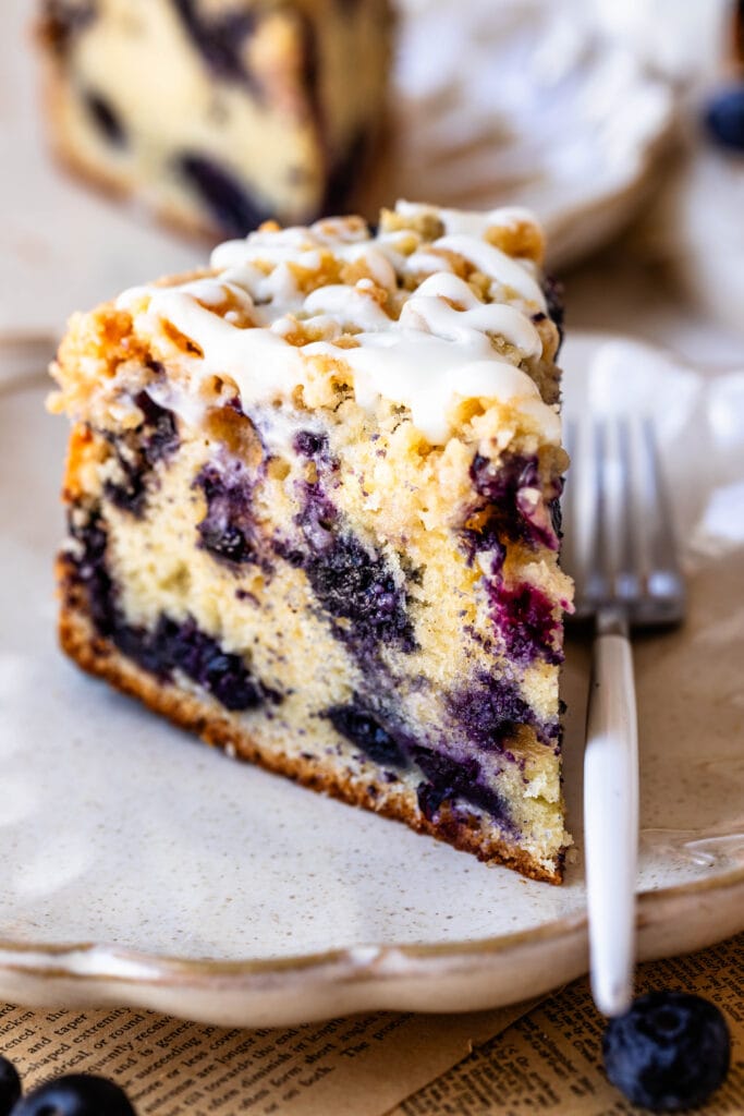 slice of blueberry coffee cake with drizzle on top.