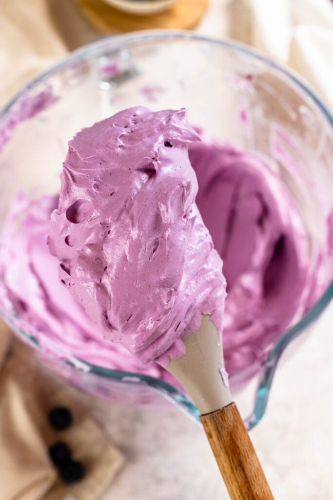 blueberry swiss meringue buttercream on a spatula.