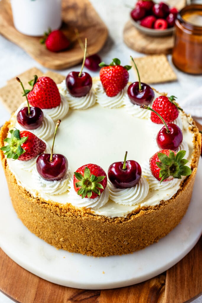 cheesecake with cherries and strawberries on top.