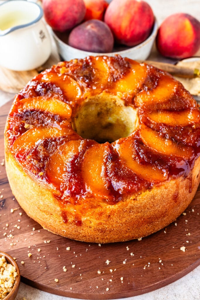 Peach Cobbler Pound Cake topped with peaches and caramel.