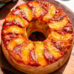 peach cobbler bundt cake with peaches and caramel on top.