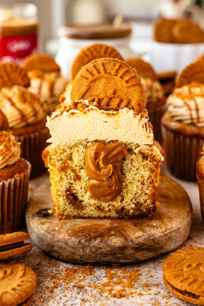 biscoff cupcake sliced in half showing biscoff filling inside.