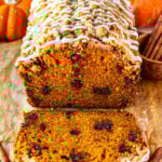 pumpkin bread with crumble on top and glaze, sliced.