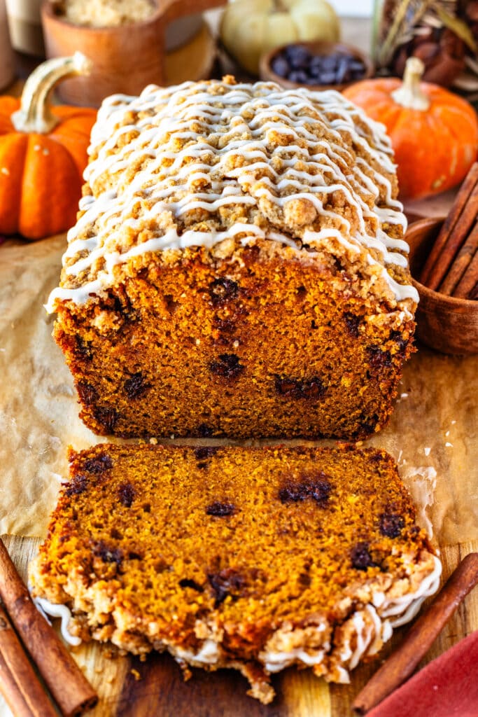 pumpkin bread with crumble on top and glaze, sliced.