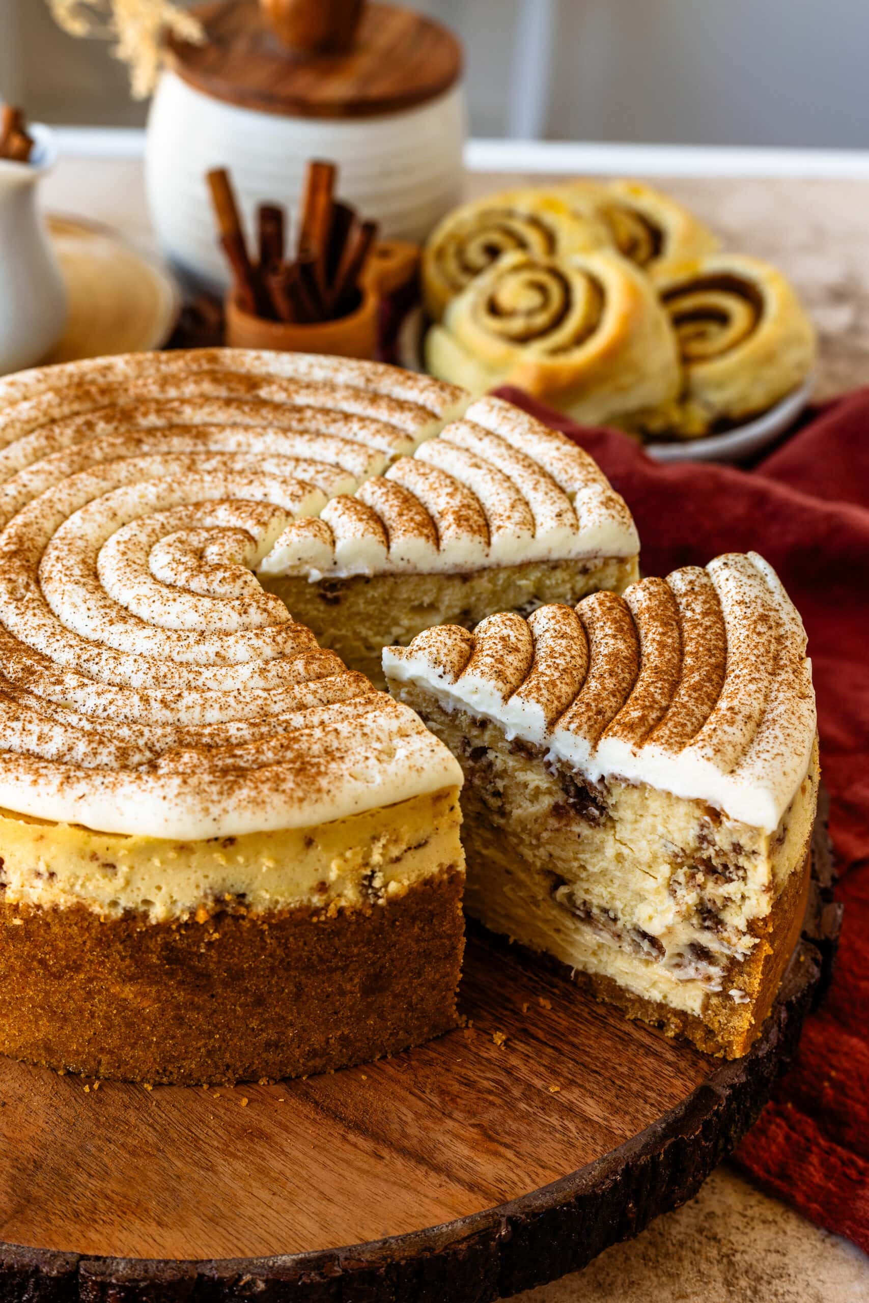 sliced cinnamon cheesecake with sprinkled cinnamon on top.