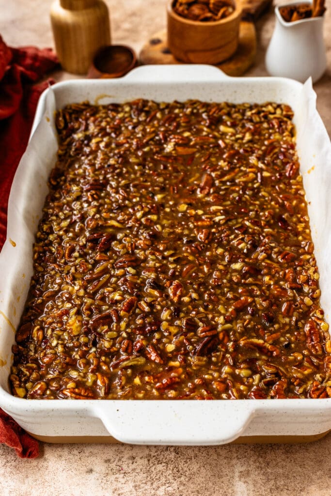 Pecan Pie Cheesecake Bars in a large baking pan.