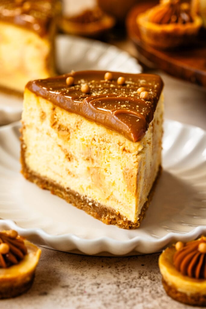 slice of dulce de leche cheesecake, topped with dulce de leche, and crispearls.