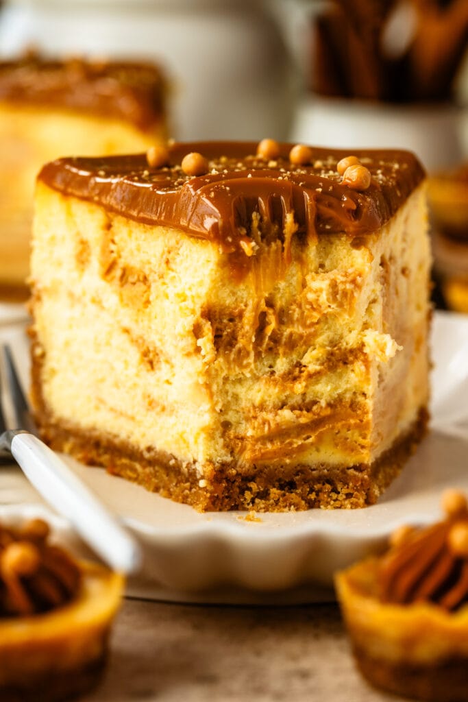 slice of dulce de leche cheesecake, topped with dulce de leche, and crispearls.
