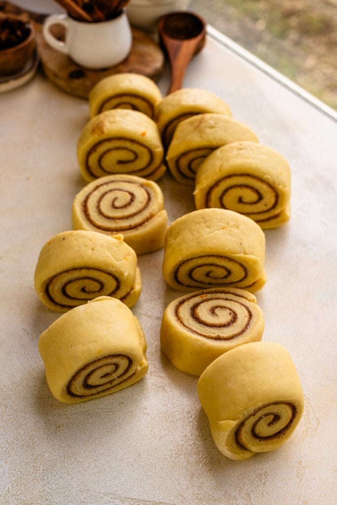 cinnamon rolls sliced on a table, before baking.