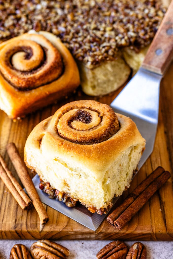 cinnamon sticky rolls with pecan caramel sauce on top.