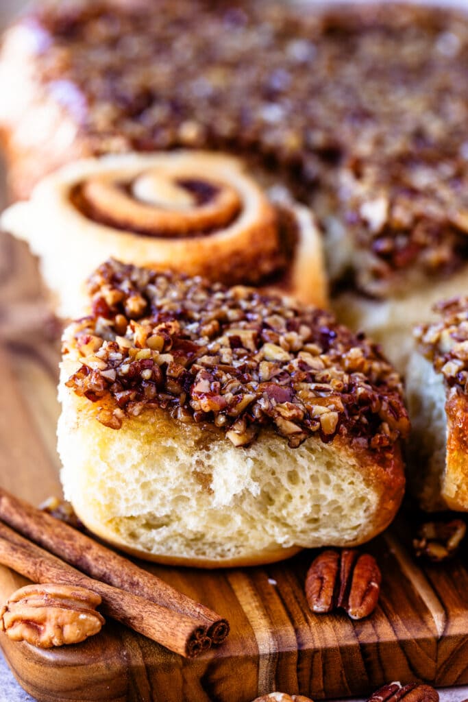 cinnamon sticky rolls with pecan caramel sauce on top.