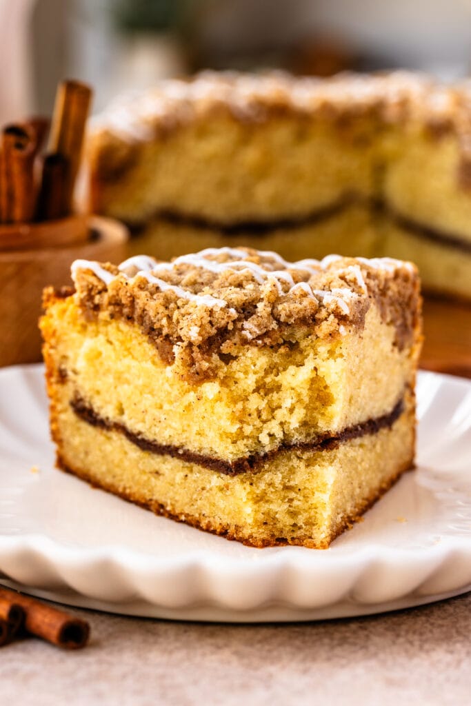 coffee cake slice with cinnamon filling, and crumb on top.