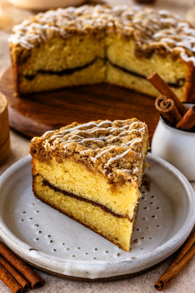 coffee cake slice with cinnamon filling, and crumb on top.
