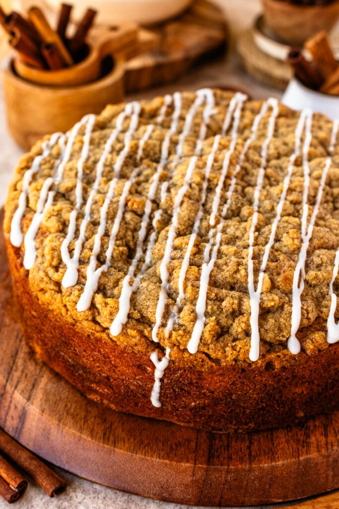 sour cream coffee crumb cake with cinnamon filling, and crumb on top, and glaze.