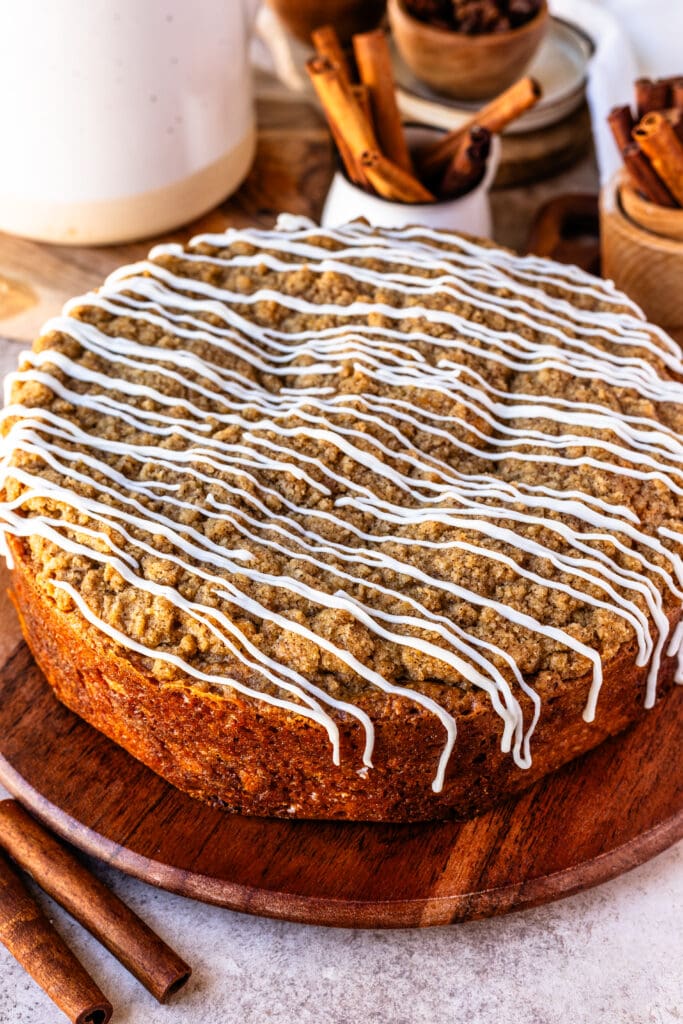 sour cream coffee crumb cake with cinnamon filling, and crumb on top, and glaze.