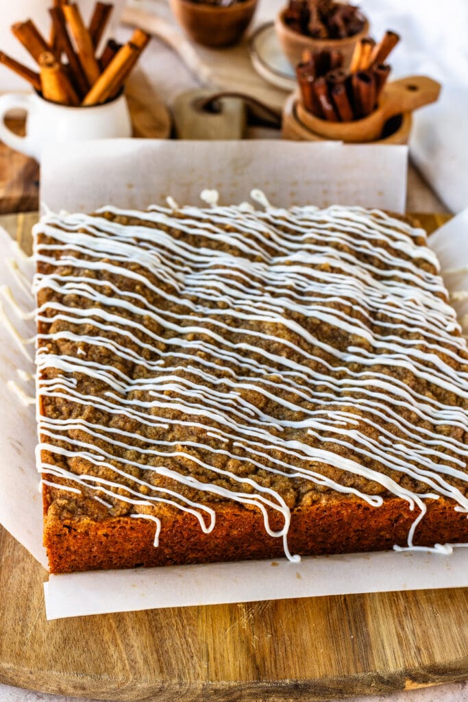 sour cream coffee crumb cake with cinnamon filling, and crumb on top, and glaze.