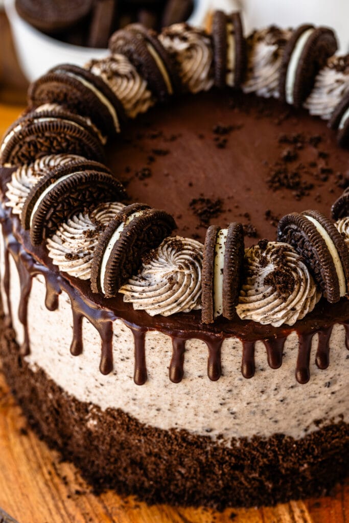 cookies and cream cake with ganache drip on top, and oreo cookies.