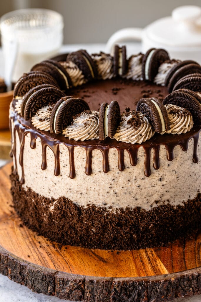 cookies and cream cake with ganache drip on top, and oreo cookies.